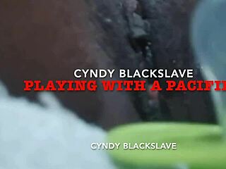 Close-up view of Cyndy Blackslave's hairless pussy as she masturbates with a pacifier